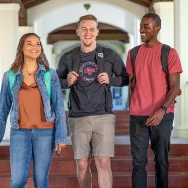 Three students walking and talking